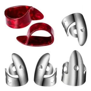 Image of metal finger picks also called banjo picks worn on the fingers of a person when playing a guitar, a banjo or a mandolin. The picture also shows two plastic thumb picks used for the same reason.