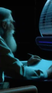 Old man having a conversation with a machine.